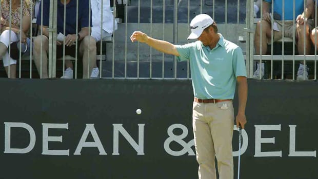 A player takes a drop away from a grandstand in 2017 at Colonial Country Club in Fort Worth, Texas.